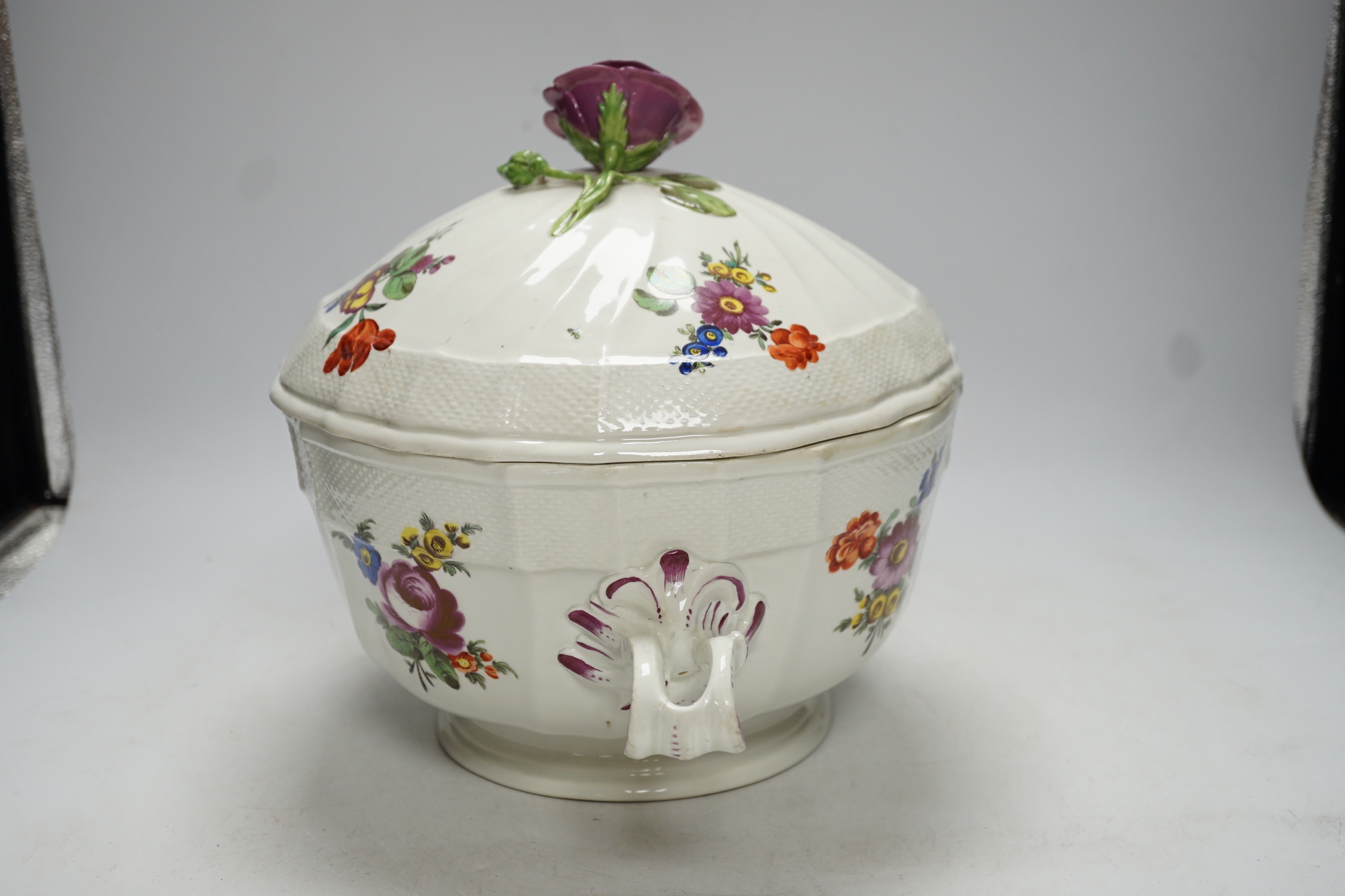 An 18th century Vienna tureen and cover, later outside decorated, with twin handles and floral knop, 38cm wide